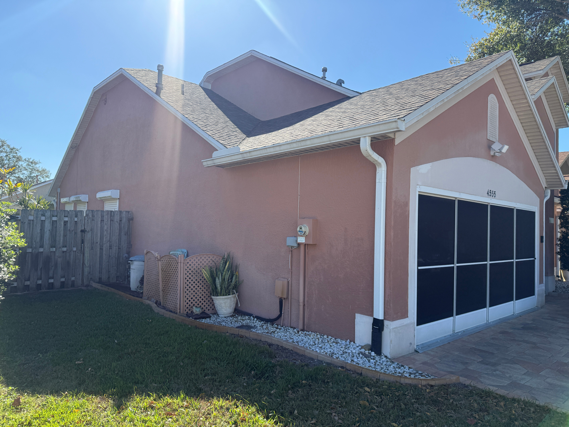 Faded pink stucco exterior of a Melbourne, FL home before repainting by Launch Painting Co.