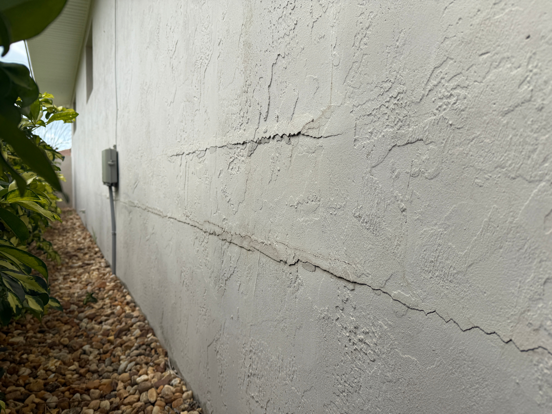 Cracked exterior stucco wall on a Satellite Beach, FL home ready for professional repair
